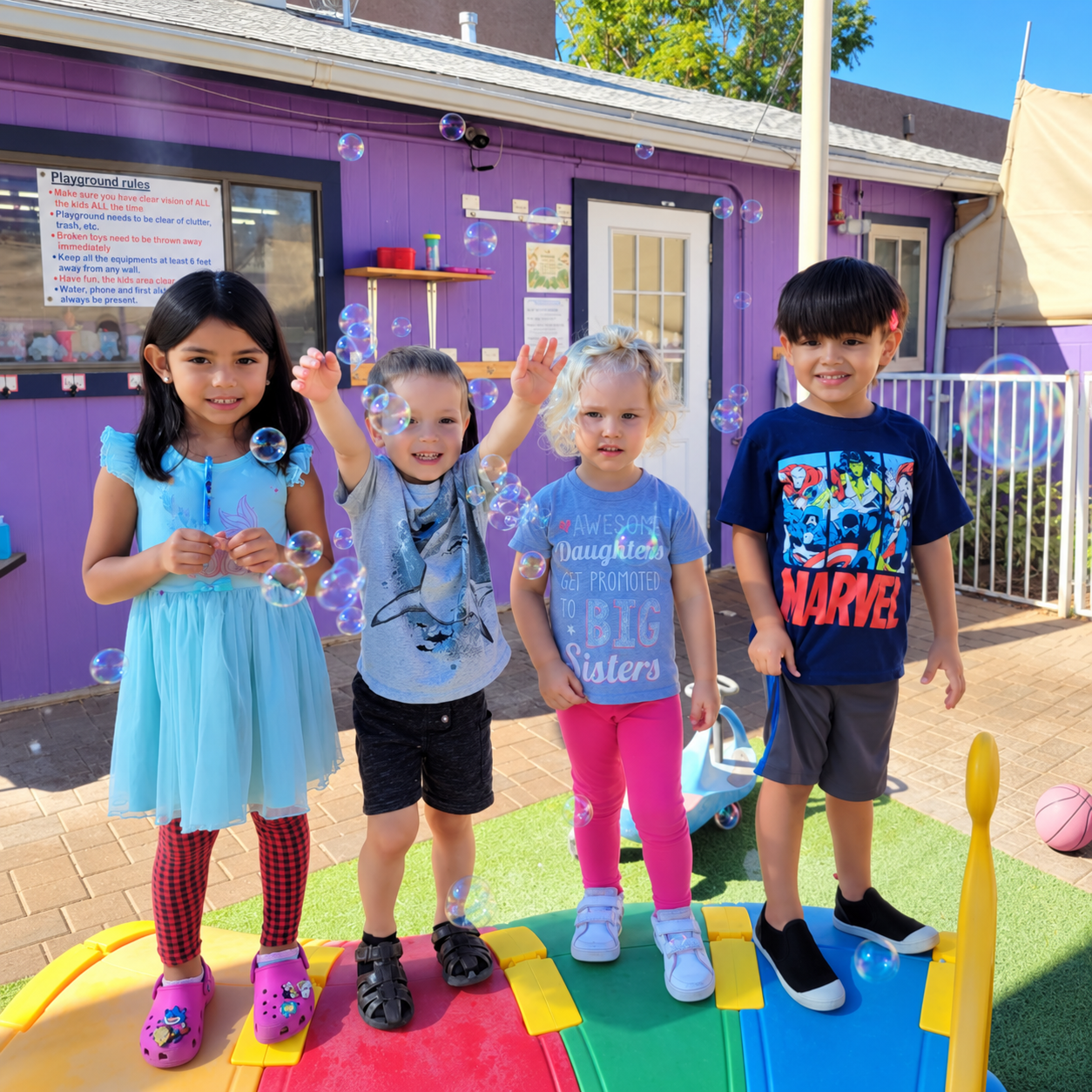 Pre-K children blowing bubbles on the playground at Kidz-Zona